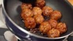 When the sauce begins to thicken, add the meatballs. Coat the meatballs with the sauce.