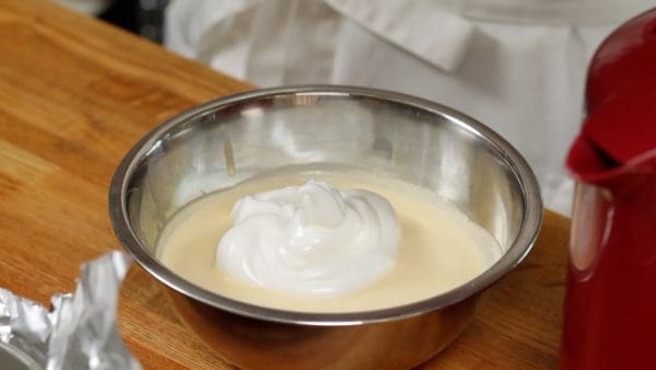 Add one-third of the meringue to the egg yolk mixture.
Mix thoroughly. At this stage, you don’t need to worry about breaking the foam.