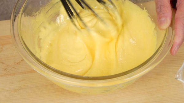 Mix the egg yolk with a balloon whisk until it begins to lighten in color.