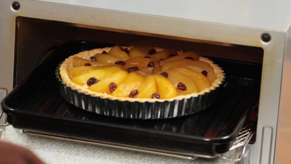 Preheat the oven to 190 °C (374 °F) and place the tart pan into it. Bake the tart at 190 °C (374 °F) for 40 to 50 minutes. To help brown the tart evenly, rotate the pan while baking. If the surface begins to burn too quickly, cover the tart with aluminum foil to adjust the color.