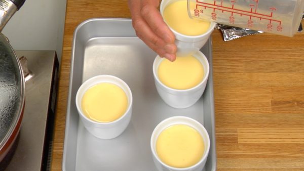 Ora scaldiamo a vapore il miscuglio di uova. Riempite cautamente le tazze per il budino con il miscuglio di uova.