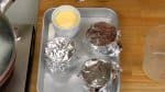 Cover each cup with aluminum foil. The foil will prevent the surface from getting dry. It will also help steam the pudding evenly.