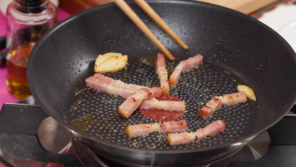 Tambahkan bacon. Tumis kembali sampai bacon berwarna kecoklatan dan harum aromanya.