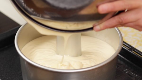 Pour the batter into the angel food cake pan. Avoid coating the pan with butter or any oil. If the pan and the cake are not firmly attached together, the cake is less likely to hold its height.