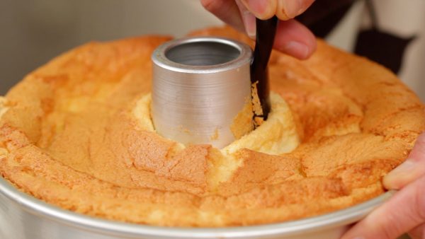 Likewise, using a small icing spatula, detach the cake from the center of the pan.