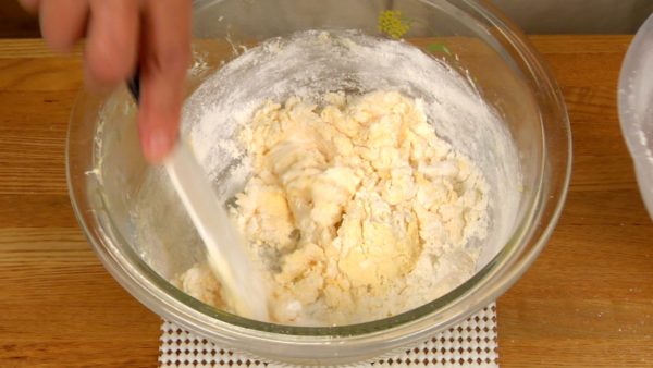 Add one third of the cake flour to the butter mixture. Lightly mix with a spatula. Add another one third of the flour and lightly mix. Add the rest and stir until all the flour is thoroughly mixed. Be careful not to overmix the dough.