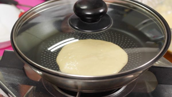 Ladle the batter into the pan. And cover.