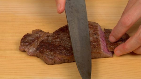 Remove the aluminum foil from the plate and place the steak onto a cutting board. Slice the beef using diagonal cuts.