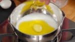 Let’s make the dough for the pão de queijo. In a small pot, combine the water, milk and the olive oil. Turn on the burner.