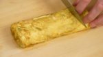 Place it onto a cutting board. Cut the tamagoyaki into 6 equal pieces. Hot tamagoyaki can easily break so make sure to cool it before cutting.