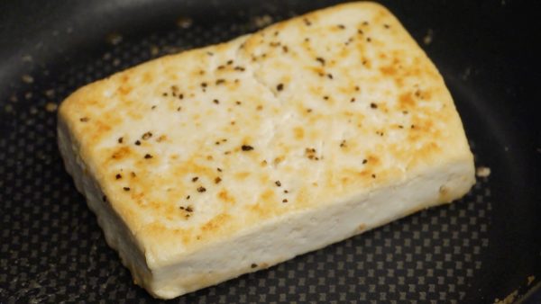 Flip the tofu over and brown the other side. Remove and place the tofu steak onto a plate.