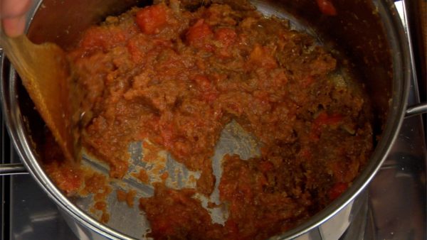 Add the diced tomatoes and continue sauteing the mixture.