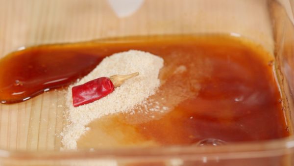 To make the nanban sauce, combine the sugar, soy sauce and the vinegar. Adding the dried red chili pepper will give the sauce a little bit of kick. Make sure to dissolve the sugar thoroughly.