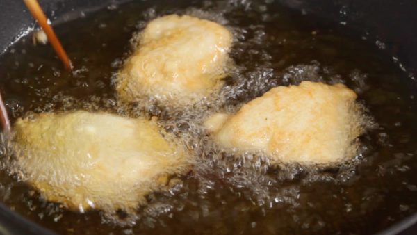 Heat the vegetable oil to about 170 °C (340 °F) and gently place the chicken into it. Let the chicken sit until the outside firms up. Then, flip the pieces over.