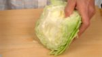 Meanwhile, remove the core of the cabbage. Take out the center part and then shred the leaves.