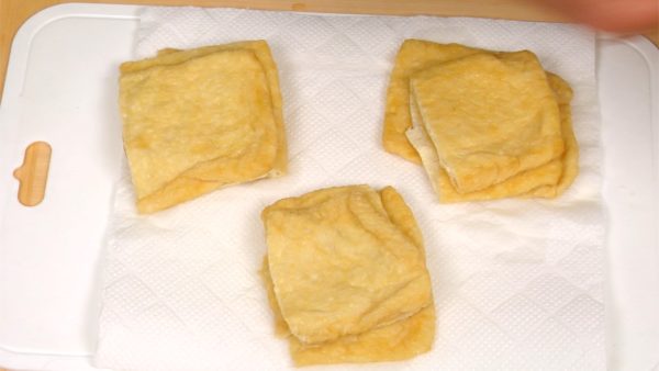 Squeeze water out of the fried tofu. Press them firmly between paper towels to remove any excess water.