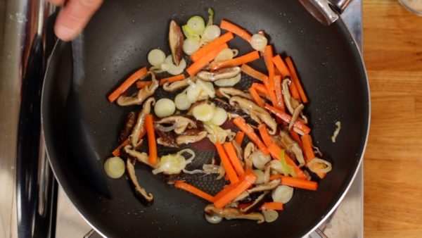 Add the carrot. Then, add the shiitake mushrooms.