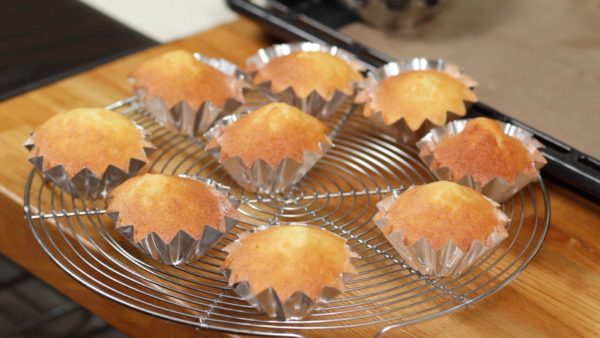 Remove the baking sheet and place it onto a trivet. With the aluminum mold still attached, place the madeleines onto a cooling rack and let them sit to cool.