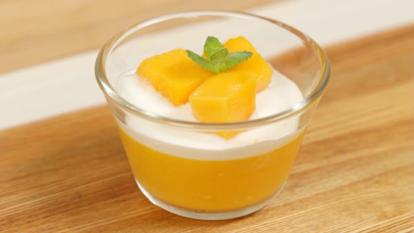 Place the diced ripe mango onto the pudding. Finally, garnish with the mint leaves.