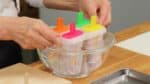 The popsicles are fully frozen. Dip the molds in a bowl of water for a moment or run them under water at the sink. This will help loosen the popsicles easily.