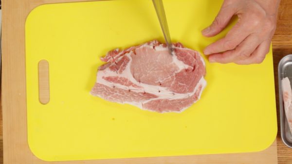 Trim off the fat from the pork loin steak. The thickness of the steak should be about 1.5cm (0.6”). Make numerous cuts along the tough stringy parts between the fat and the lean meat. Be sure to bring the meat to room temperature before cooking. This will help to avoid undercooking the inside.
