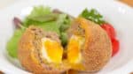 Place the scotch egg onto a plate along with the salad. Enjoy the dish with mustard or you can add your favorite sauce to taste.