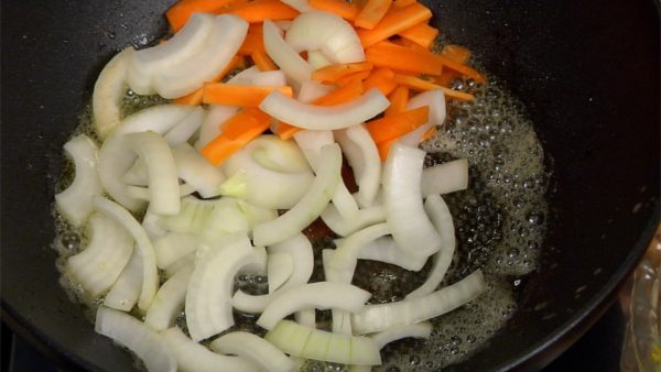 Tilt the pan toward you and remove the excess oil with a paper towel. Add the butter and olive oil to the pan and turn the heat to medium. Swirl the pan and let the butter melt. Put the chopped onion and carrot in the pan at once.