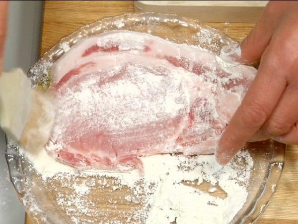 Dust both sides of the pork slice with the all-purpose flour.