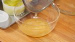 Press the seeds and core with a spoon to extract the melon juice. We will be making a delicious melon cream soda at the end of this video.