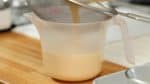 Strain the egg mixture into a pitcher. This will help the pudding to have a smooth texture. Remove the foam on the surface with a spoon.
