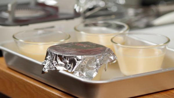 Cover each cup with a piece of aluminum foil. This will help to keep the surface from drying out.
