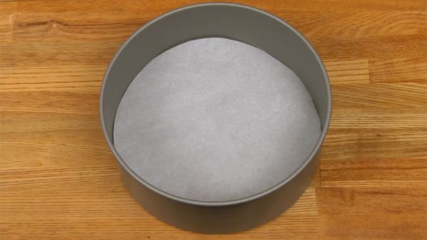 Line the removable bottom of the cake pan with wax paper.