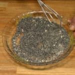Finely grind the black sesame seeds with a suribachi mortar and surikogi pestle. Add the sugar and combine well, making the black sesame topping.