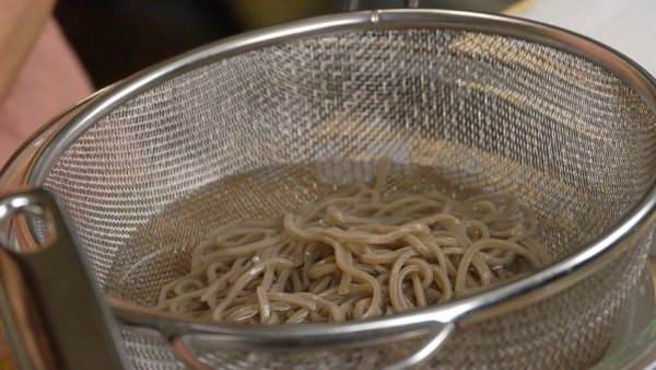Allow the soba to cool in a bowl of ice water. Then, squeeze out the excess water and place the soba into a bowl.