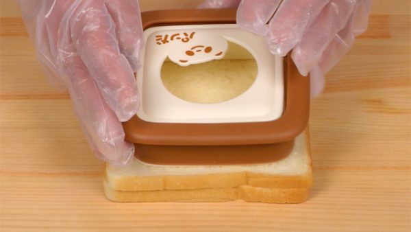 Cover the fillings with another slice of bread. Cut out the bread crusts with the cutter.