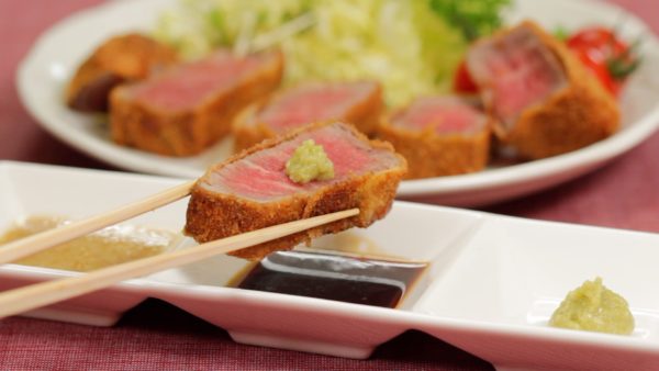 Enjoy the Gyukatsu with the sesame miso sauce. You can also place the wasabi on the meat and lightly dip it in the kombu soy sauce.