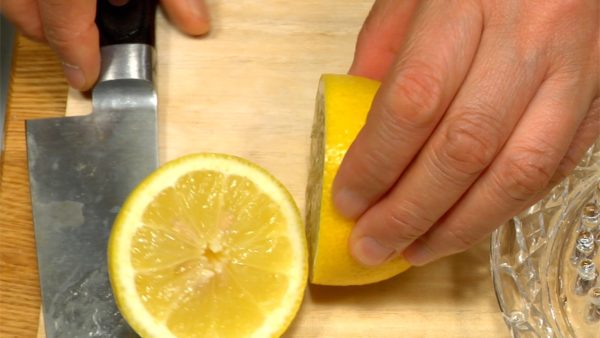 To get most of the juice out of the lemon, roll it on the chopping board while pressing down. Cut the lemon in half and squeeze.