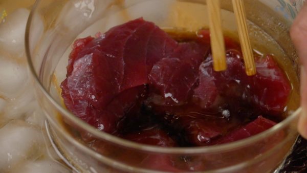 Place the tuna into the chilled marinating sauce. Make sure to submerge the slices in the sauce and let them sit for 10 to 20 minutes.