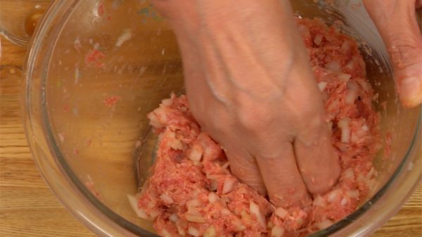 With your hands, thoroughly mix the ingredients until the onion blends in completely with the meat.