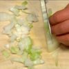 Cut the onion into fine pieces by making vertical cuts along the grain and then slicing across the initial cuts so each piece is cut evenly. Remove the stems of the button mushrooms. Slice the mushrooms into quarter inch slices.