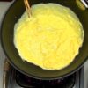Stir vigorously with chopsticks for 5 seconds. Swirl the egg mixture around, allowing it to completely cover the bottom of the pan. Turn off the burner. The egg is half-cooked at this stage.