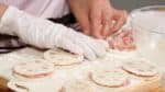 With the flour side facing down, place another slice onto the filling, making sure they attach firmly together. Repeat the process and make 8 pieces of stuffed lotus root. Finally, adjust the shape of each lotus root.