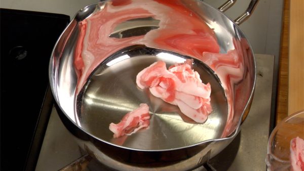 つけ汁を作りましょう。温めた鍋に豚バラ肉の脂の多い部分を入れます。