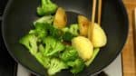 Remove the lid, and stir the vegetables. Toss the pan to cook evenly and place the vegetables on a plate. Serve the tomato, broccoli and potato on a plate.