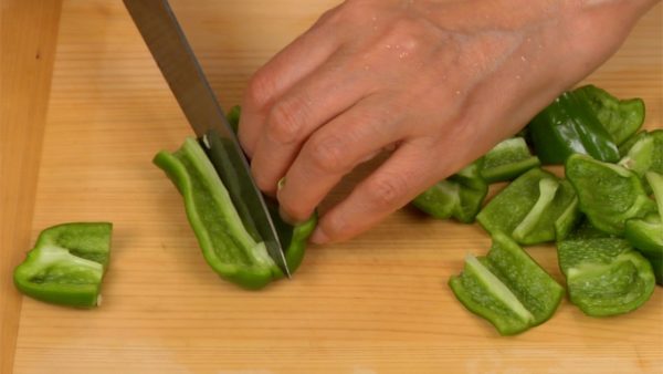 Cut the bell peppers in half lengthwise and remove the stem ends and seeds. Then, cut the peppers into slightly smaller pieces than the eggplants.