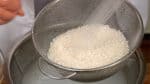 Gently rinse the rice under running water. Be careful not to split the rice grains.