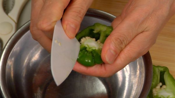 Let’s cut the vegetables and mushrooms. Cut each of the bell peppers in half lengthwise. Remove the stems and the seeds. Clean the inside of the bell peppers.