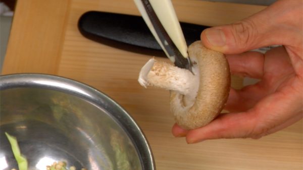With kitchen scissors, remove each of the stem ends from the shiitake mushrooms. Cut off the stems of the shiitake mushrooms.