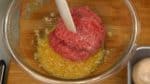 When combined, add the ground beef and pork mixture and mix thoroughly until it begins to become gooey.