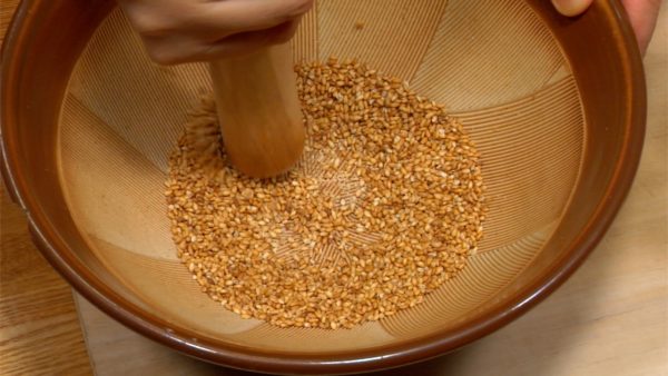 Put the sesame seeds in a suribachi bowl and grind them with a surikogi pestle. 